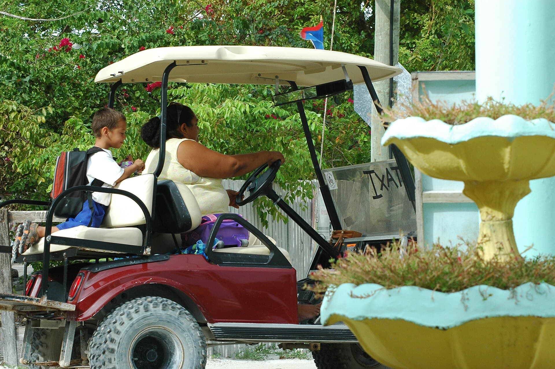 A golf-cart taxi on a sandy street — Caye Caulker, Belize