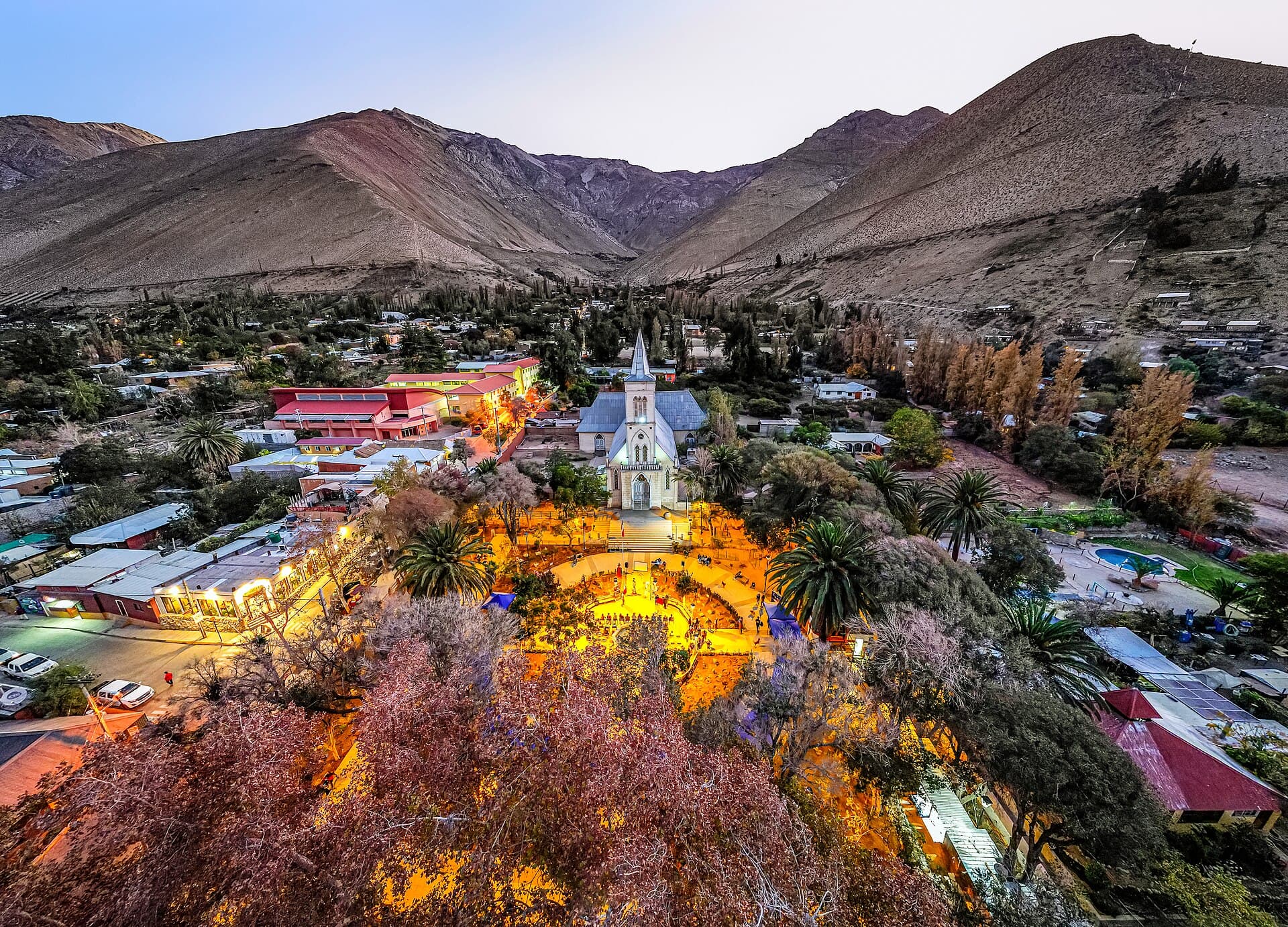 Aerial of the town with its dark-sky-friendly lit plaza at dusk — Pisco Elqui, Chile